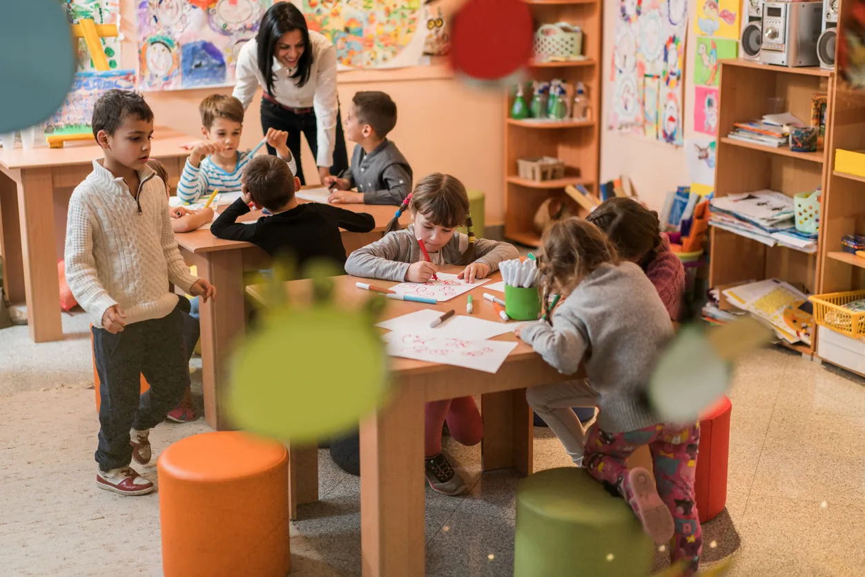 children drawing in classroom setting